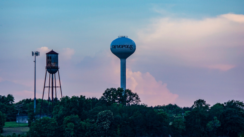 A water tower looms above a town at sunset in Marengo County, Alabama