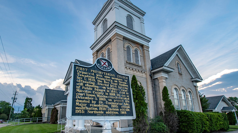 A sign describing the rich history of a place stands outside a church in Marengo County, Alabama