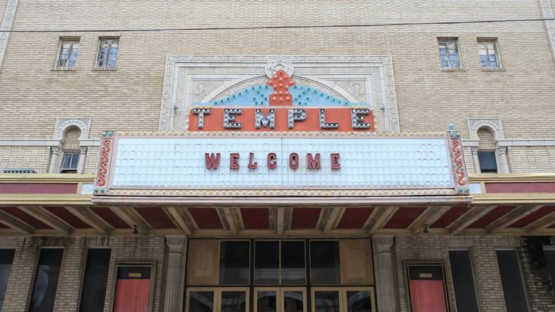 The front doors and antique signage adorning Temple Theatre's facade in Meridian, Mississippi.