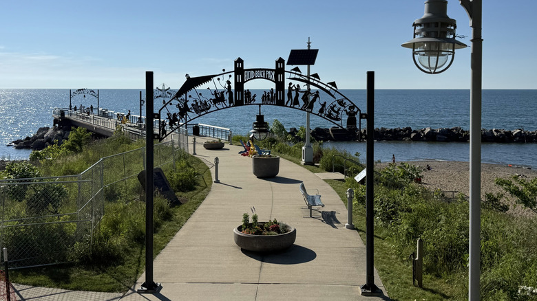 Pier at Euclid Beach, with a lamppost and black metal arch in the foreground