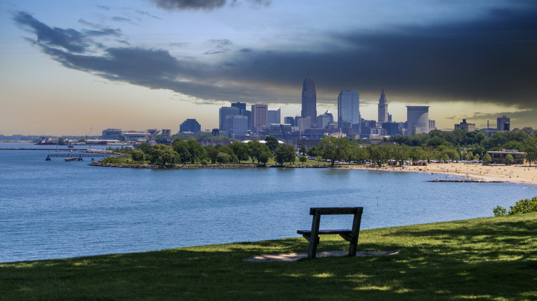 Grass with a bench overlooking blue waters of Lake Erie and the Cleveland skyline