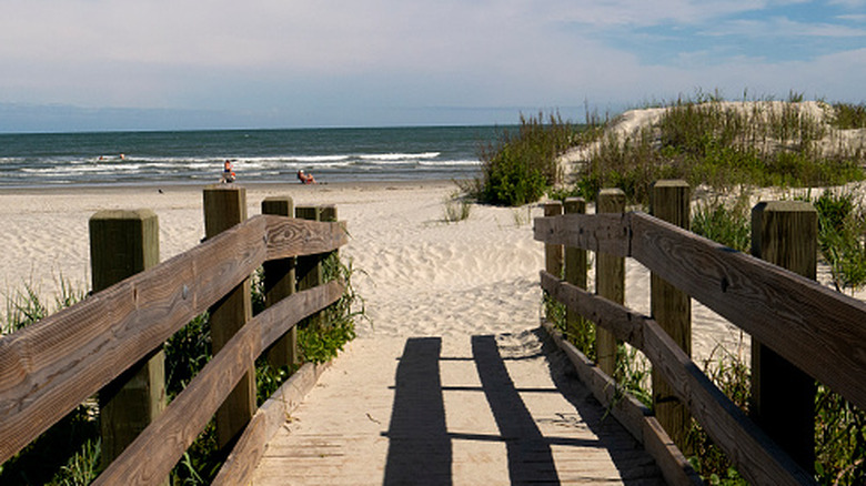 The Point in Cherry Grove, South Carolina, where the inlet meets the ocean with sand and rolling waves.
