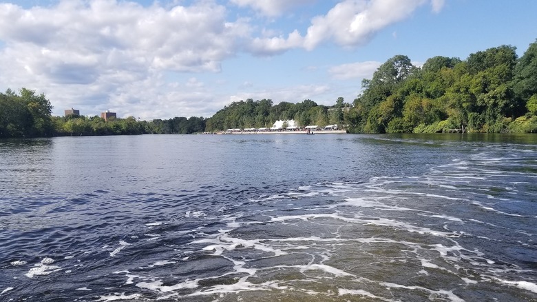 A view of a river with wooded banks in Pawtucket