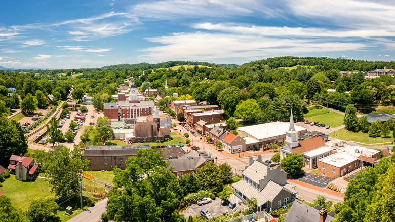 An aerial view of Jonesborough, Tennessee, with old buildings, lush trees, and blue skies.