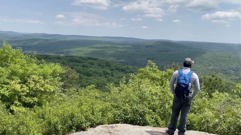 Man enjoying view from the top of Peaked Mountain