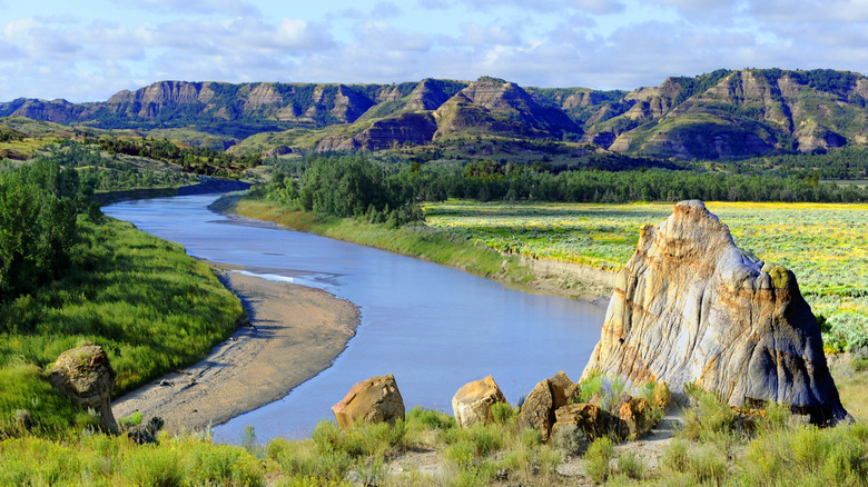 A river weaves between mountain bluffs in the Theodore Roosevelt National Park