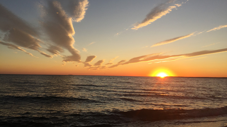 the sun dips below the horizon at Hammonassett Beach State Park in Connecticut