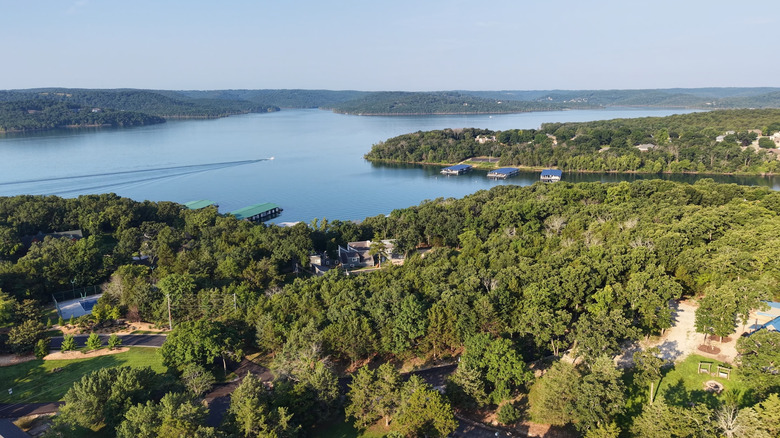 Lake of the Ozarks surrounded by land full of dense trees and buildings in Camden County, Missouri