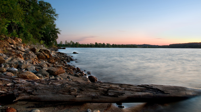 A rocky beach on Lake Hartwell seen during a colorful sunset