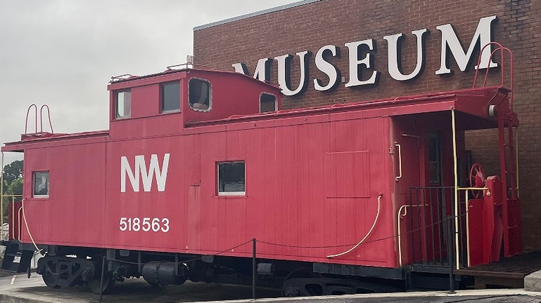 A historic red train carriage seen outside South Boston-Halifax County Museum of Fine Arts and History