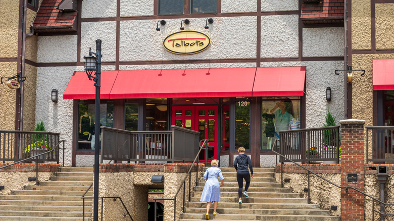 Two people mounting stairs toward a Talbots storefront in Historic Biltmore Village, North Carolina.