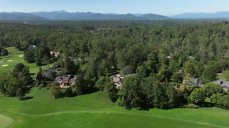 Aerial view of homes and woodlands in Biltmore Forest with Blue Ridge Mountains in the background, North Carolina