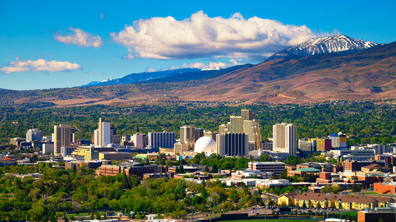 An aerial view of Reno, Nevada, with snow-capped mountains overlooking the city
