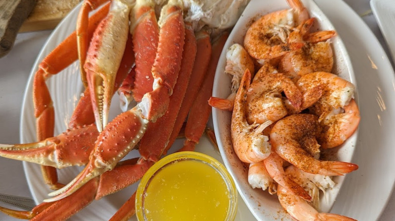 Plate of crab legs and shrimp with side of butter at Tale of the Whale restaurant in Nags Head, North Carolina