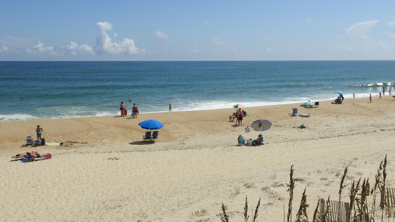 Visitors relaxing on beach in Outer Banks, North Carolina
