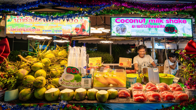 Food vendors selling fruit shakes at a night market on Koh Samui