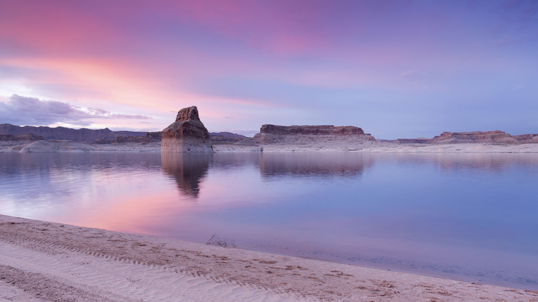 A still Lone Rock Beach on Lake Powell during a pink sunset
