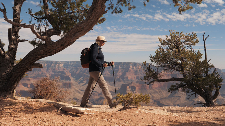 A retirement-aged woman hiking on the rim of the Grand Canyon in Arizona