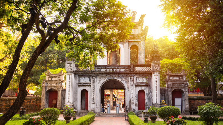 Main gate of a temple with arched doorways in Hanoi in the sunset