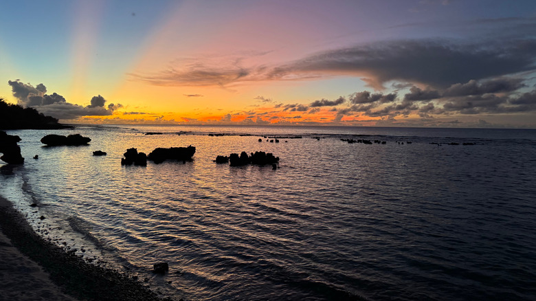 The sun sets over a beach on the island of Rota, Northern Mariana Islands