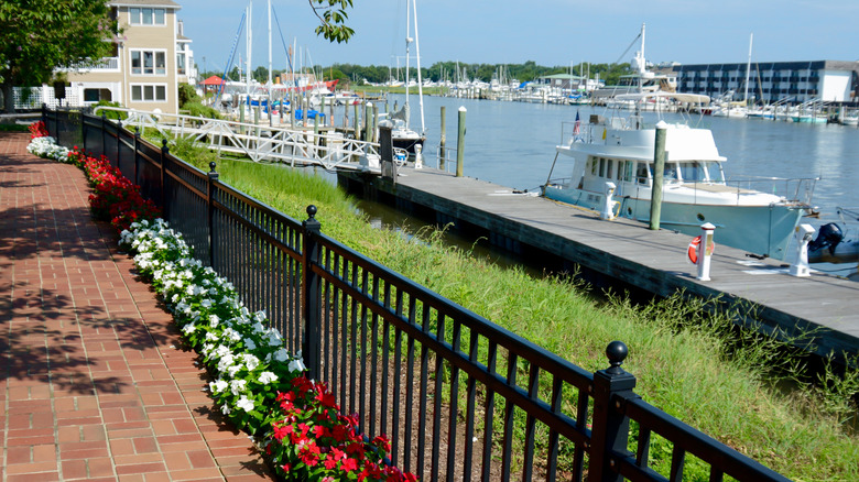 View of pathway along canal in Lewes Delaware with boat in background