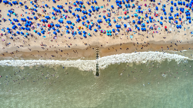 Ariel photos of umbrellas and people on the beach at Rehoboth Beach Delaware.