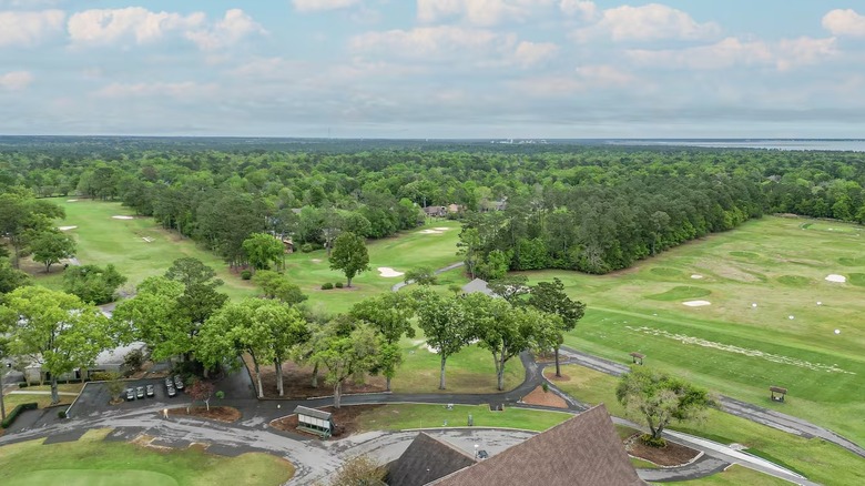 The golf course and driving range surrounded by trees at Diamondhead in Mississippi.