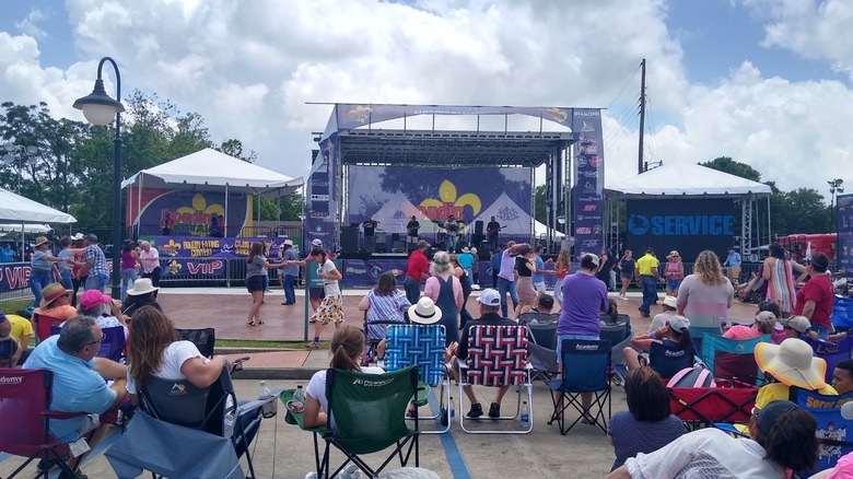 People dancing and sitting near stage at Scott Boudin Festival