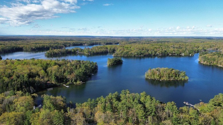 An aerial view of Spider Lake on a sunny day in Grand Traverse County, Michigan