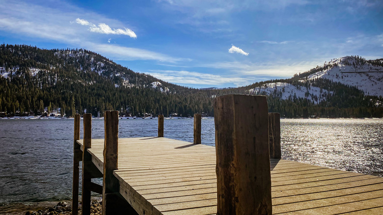 Wooden pier on Donner Lake, California with a view of snow-capped peaks