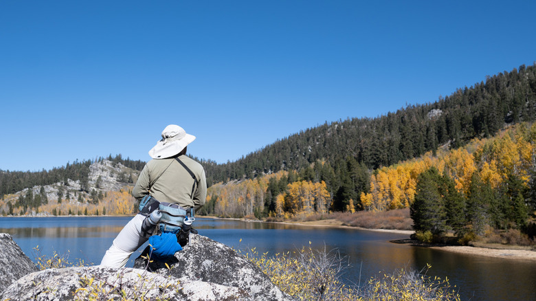 A person sitting on a rock at Marlette Lake