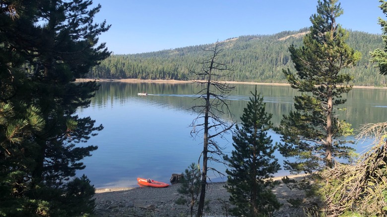An orange kayak on the shore of Jackson Meadow Reservoir