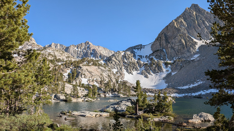 One of the Treasure Lakes framed by snow-capped mountains in California.