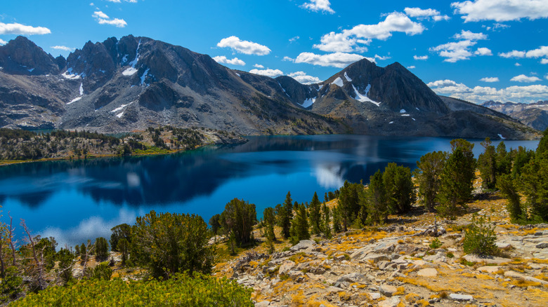 Duck Lake, framed by evergreen-lined shores and towering mountains in the background.