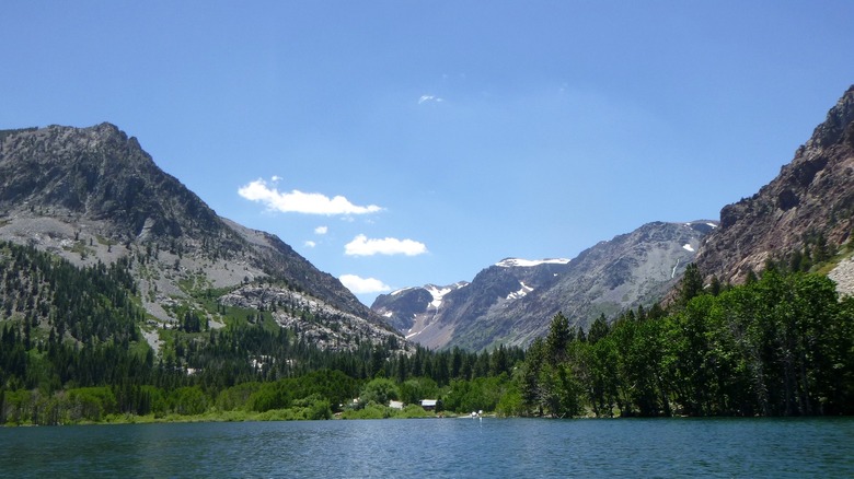 Deep blue Lundy Lake with towering mountains and blue skies.