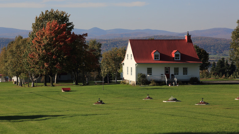 Aerial view of a farmhouse and distant hills on Île d'Orléans in Quebec
