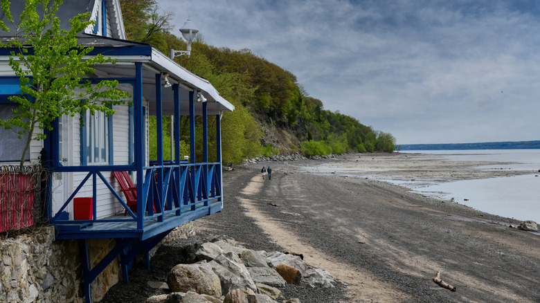 House and a beach at Quai du Cap-﻿Santé on a dark, cloudy day in Cap-﻿Santé, Quebec