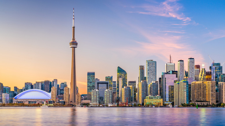 Toronto skyline with the CN Tower and skyscrapers against sunset sky