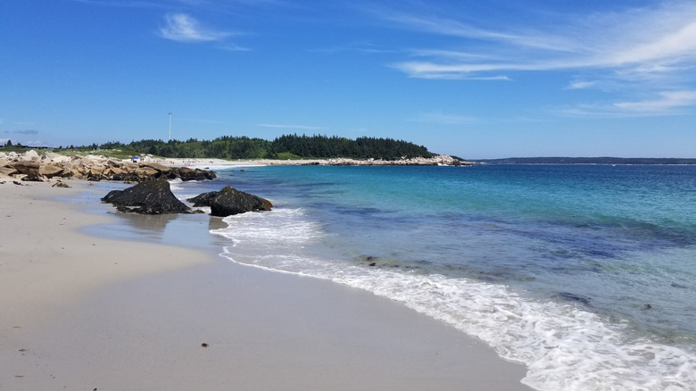 Turquoise waves lapping the white sand beach in the Southern shore