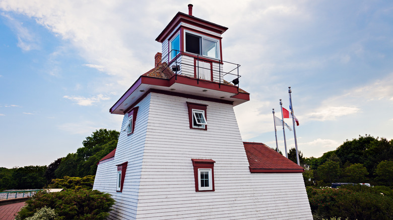 White and red Fort Point Lighthouse structure against clear sky