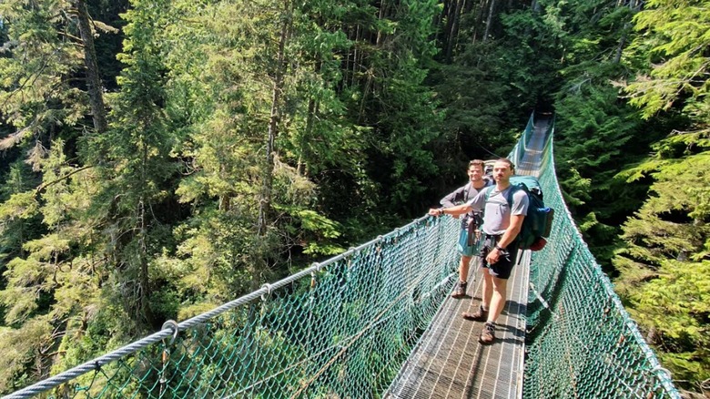 Hikers on suspension bridge at Juan de Fuca Provincial Park