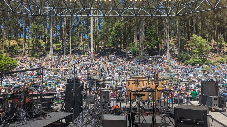 Concert stage filled with musical equipment overlooking a large crowd at Sigmund Stern Recreation Grove, California