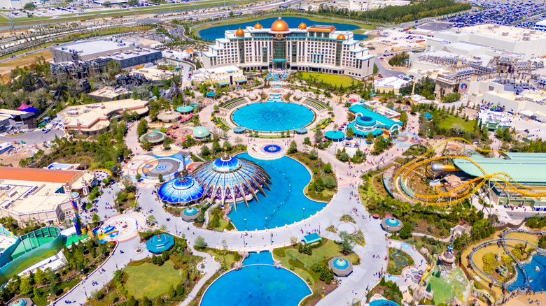 An aerial view of an amusement park in Orlando, Florida with roller coasters and water features.