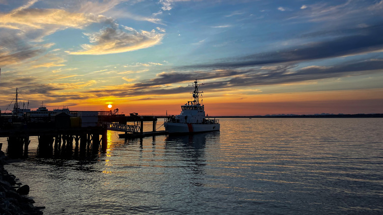 A dock and a boat at sunset on the Salish Sea in Bellingham, Washington