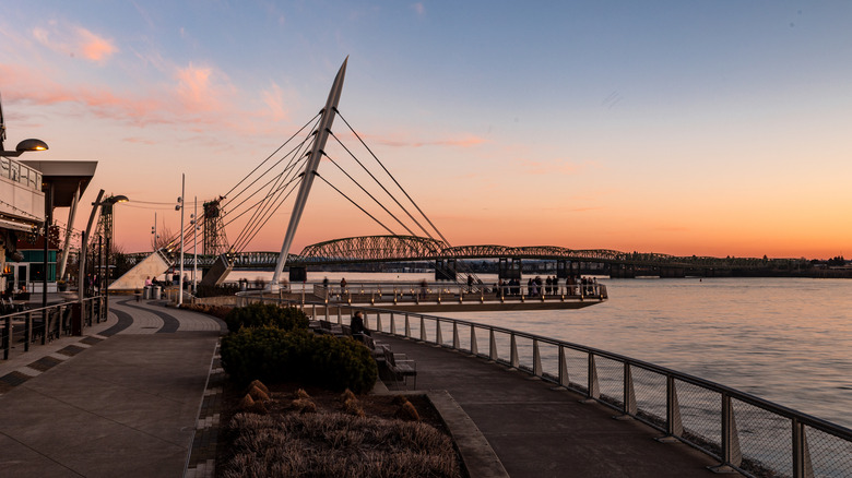 View of Vancouver, Washington's, riverside walkway at sunset with a bridge and a viewing deck