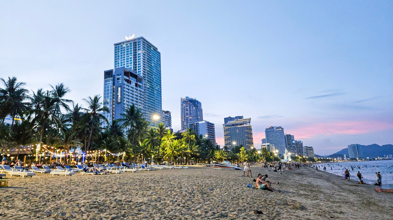 The city skyline backdrops the sand of Tran Phu Beach, Nha Trang, Vietnam's municipal beach in the heart of the city