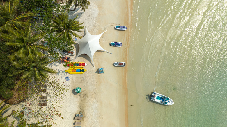 Boats launching into the water at Sao Beach, Phú Quốc Island, Vietnam