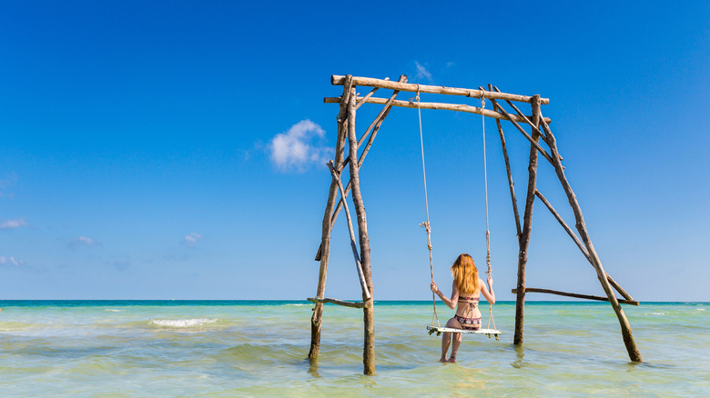 Woman on a swing at Sao Beach, Phú Quốc Island, Vietnam
