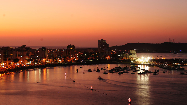 Sunset view of coastal city with orange sky, Salinas, Ecuador