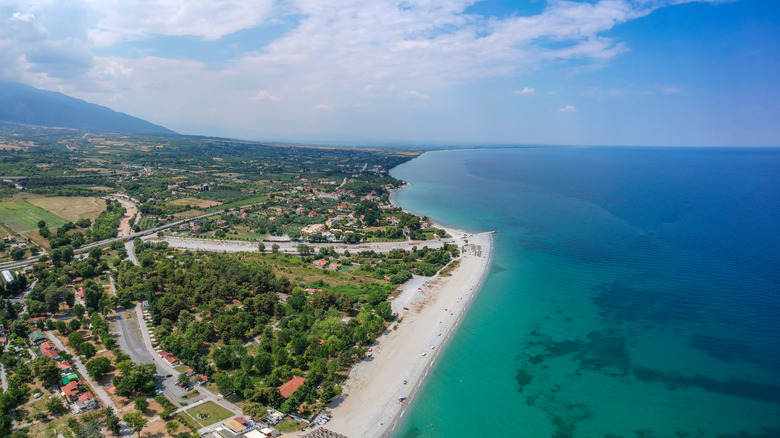 Dwellings dot the coast where white sand meets turquoise water